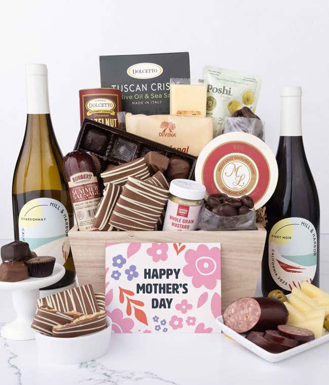 Wooden Mother&rsquo;s Day gift crate filled with two bottles of Hill &amp; Harbor wine, summer sausage, brie, cheeses, Tuscan crisps, chocolates, pretzels, and gourmet snacks, displayed with a Mother&rsquo;s Day card.