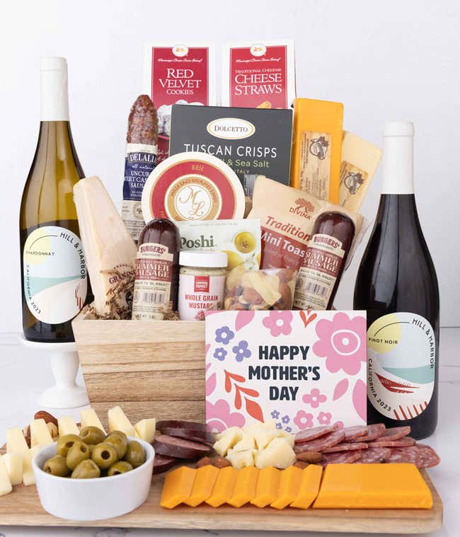 Mother&rsquo;s Day charcuterie collection with Hill &amp; Harbor Pinot Noir and Chardonnay, artisan salami and sausages, cheeses, olives, crisps, cookies, and savory snacks, displayed with sliced meats, cheeses, and floral card.