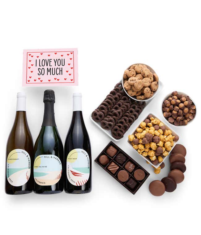 A gift set with 3 bottles of wine - red, white and sparkling, paired with chocolate pretzels, caramel popcorn, mini cookies, chocolate peanut butter buckeyes, six chocolate-covered Oreos, assorted chocolates, and a touching 'I Love You' card.