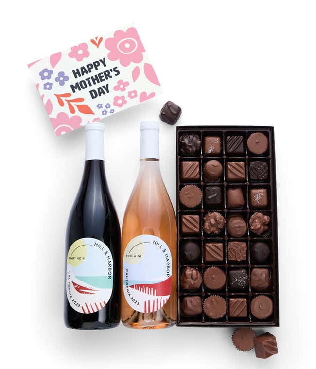 Bottles of Hill &amp; Harbor Pinot Noir and Ros&eacute; wine sit alongside a 1 lb. box of assorted chocolates and a 'Happy Mother's Day' card.