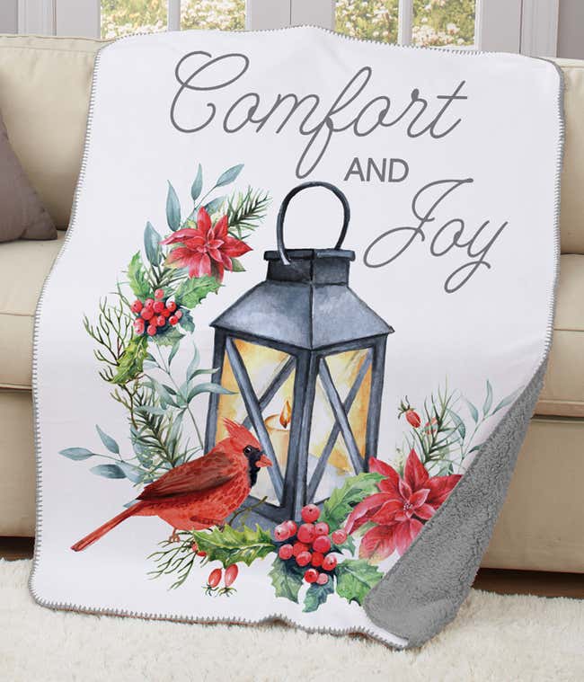  Comfort &amp; Joy Sherpa blanket featuring a red cardinal, lantern, and festive florals in watercolor design.