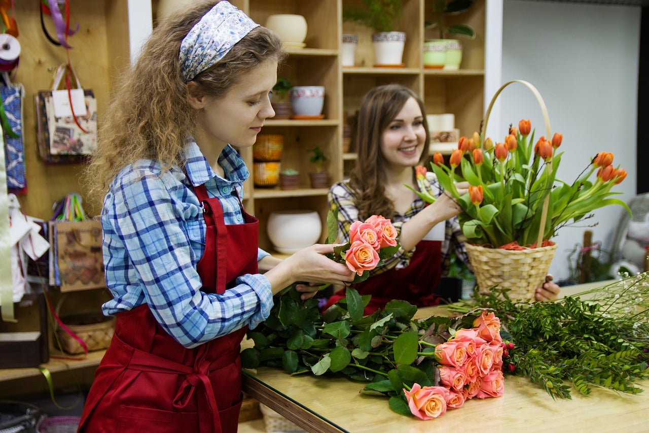 Florist Working In Her Flower Shop. by Stocksy Contributor